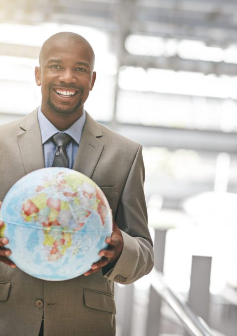 Cropped portrait of a businessman holding a globe.