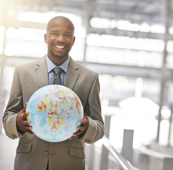 Cropped portrait of a businessman holding a globe.