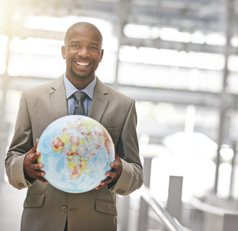 Cropped portrait of a businessman holding a globe.